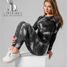 a woman is wearing a black& white sportswear for gym 