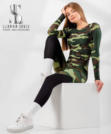 A woman is wearing a green camouflaged sportswear for gym 