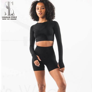a woman is wearing a black sportswear for gym