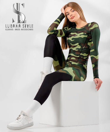 A woman is wearing a green camouflaged sportswear for gym 
